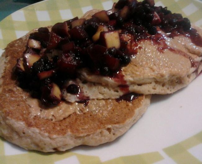 Oatmeal pancakes with peanut butter and stewed fruit.